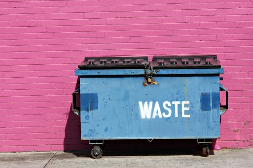 Company van beside a residential skip on pavement