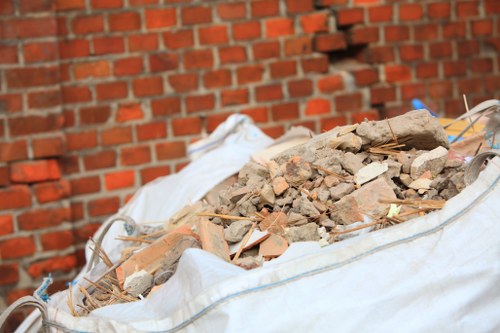 Grab lorry collecting waste at a construction site in Stratford